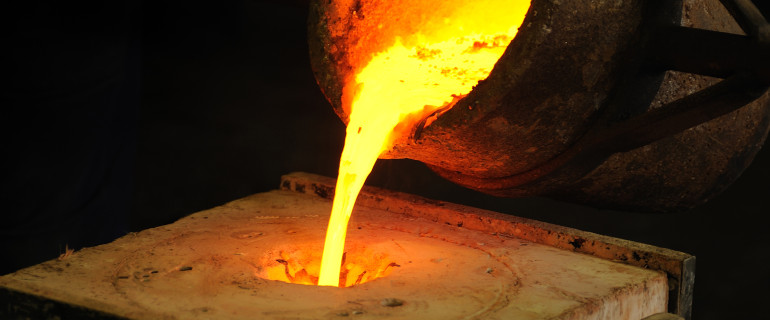Foundry - molten metal poured from ladle into mould - lost wax casting