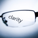 Word "clarity" viewed from a glasses.
