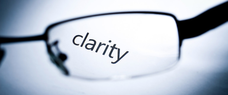 Word "clarity" viewed from a glasses.